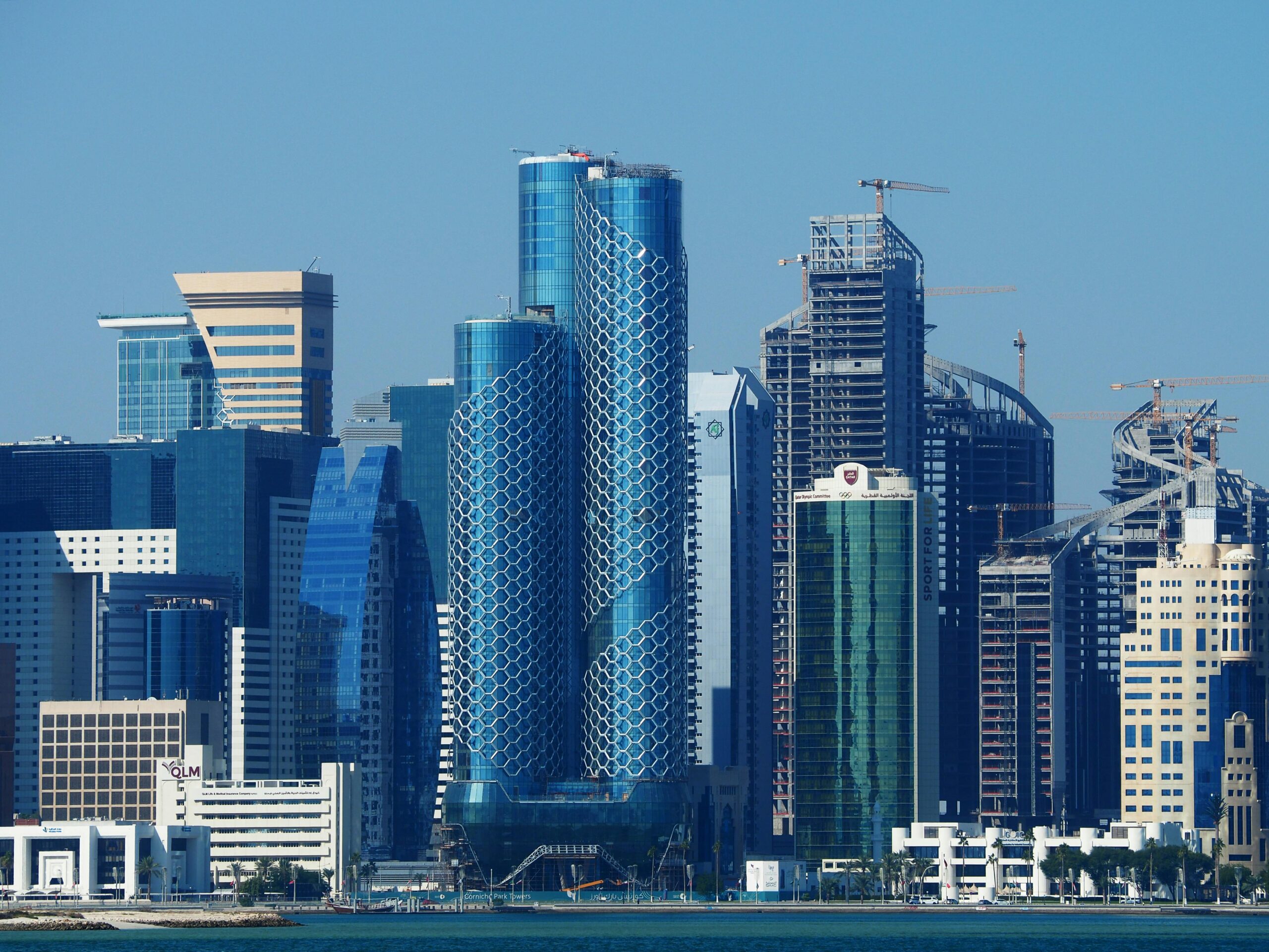 Explore the futuristic skyline of Doha, showcasing modern architectural designs and towering skyscrapers.